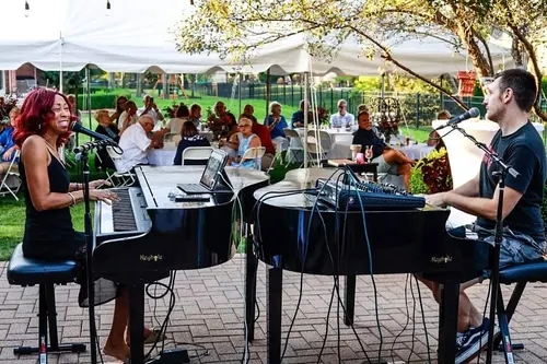 Dueling pianos under a tent at an outdoor Michigan wedding