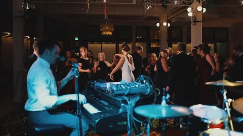 Dueling pianos with drums at a wedding reception