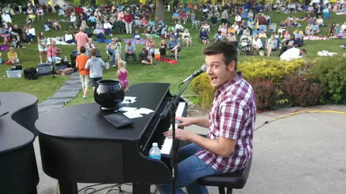 Dueling pianos on an outdoor lawn stage