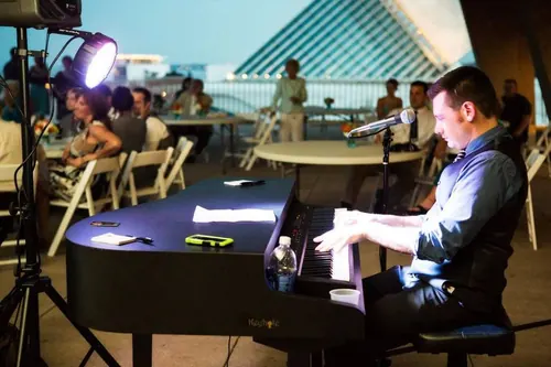 Frank performing on a rooftop deck