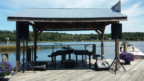 Grand piano on a lakeside dock before a private party