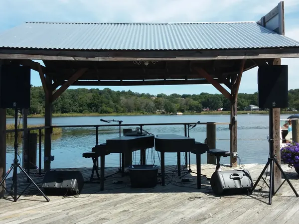Grand piano set up on a lakeside dock for a private party